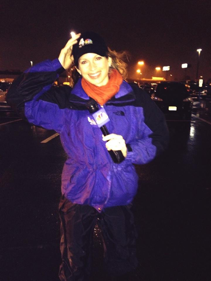 Jen in the field reporting on a rain storm. It looks windy.